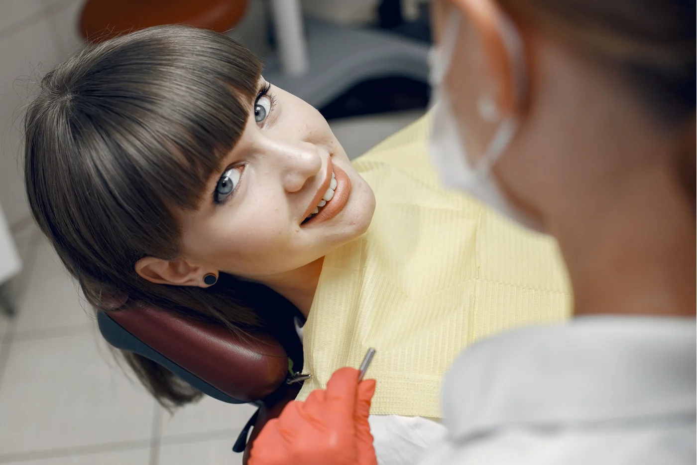 Person speaking with a dentist during a first dental visit discussion