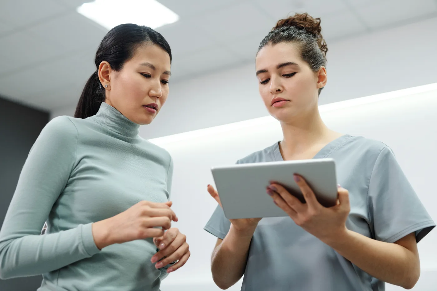Patient discussing dental information with a clinician using a tablet